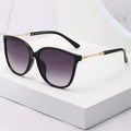 Oversized Cat-Eye-Sonnenbrille Schwarz-Gold